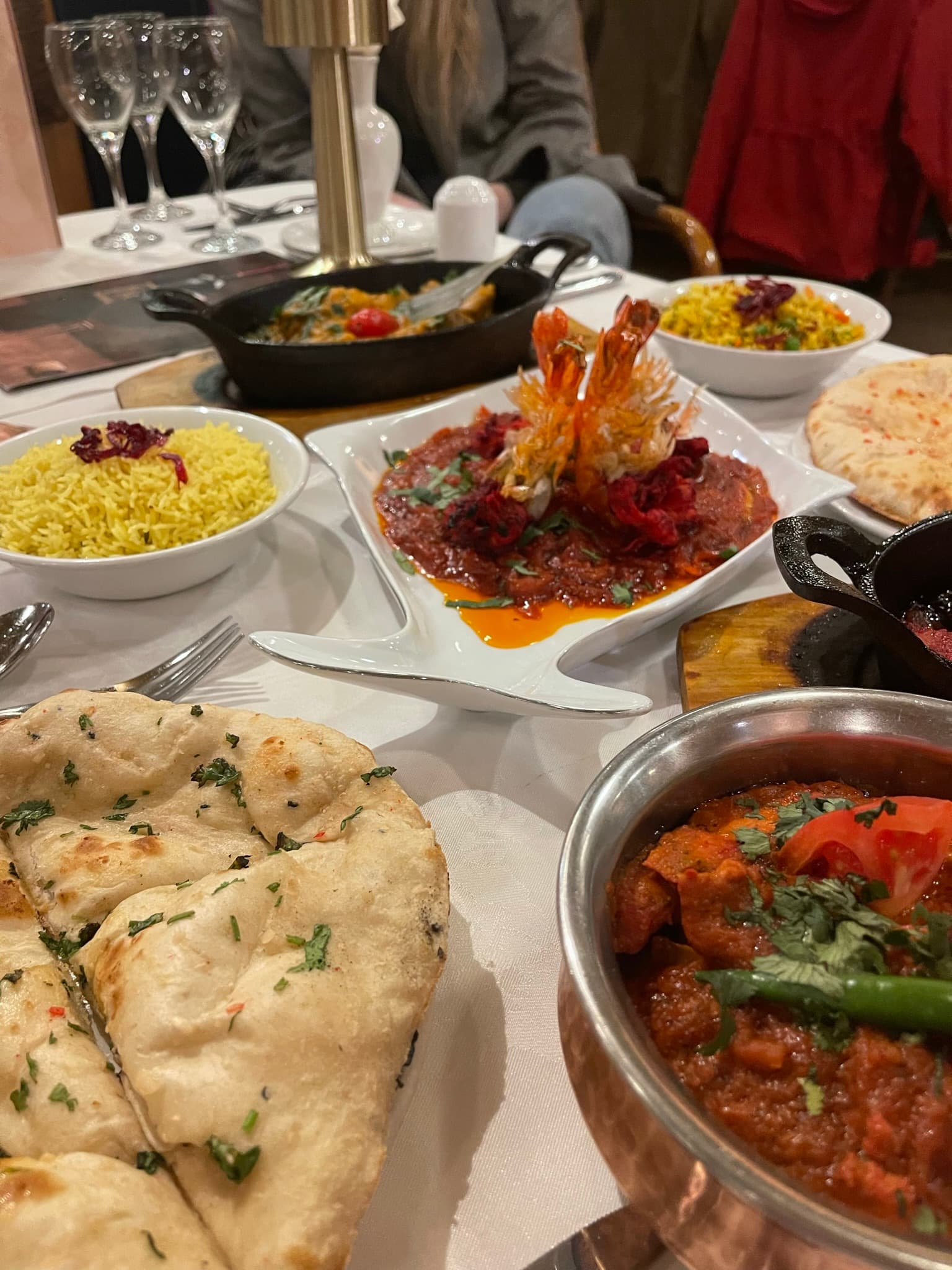 Naan, king prawns and curries on a candlelit table